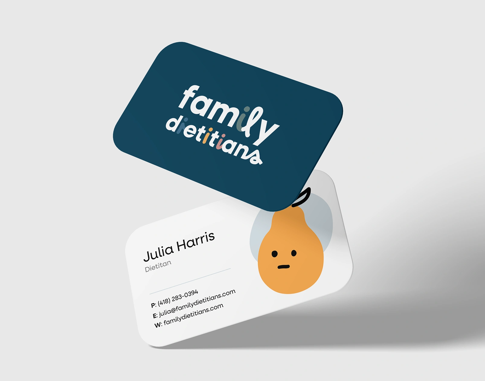 Front and back of a Family Dietitians business card: the white logo on navy, and a dietitian’s contact details beside a smiling pear illustration