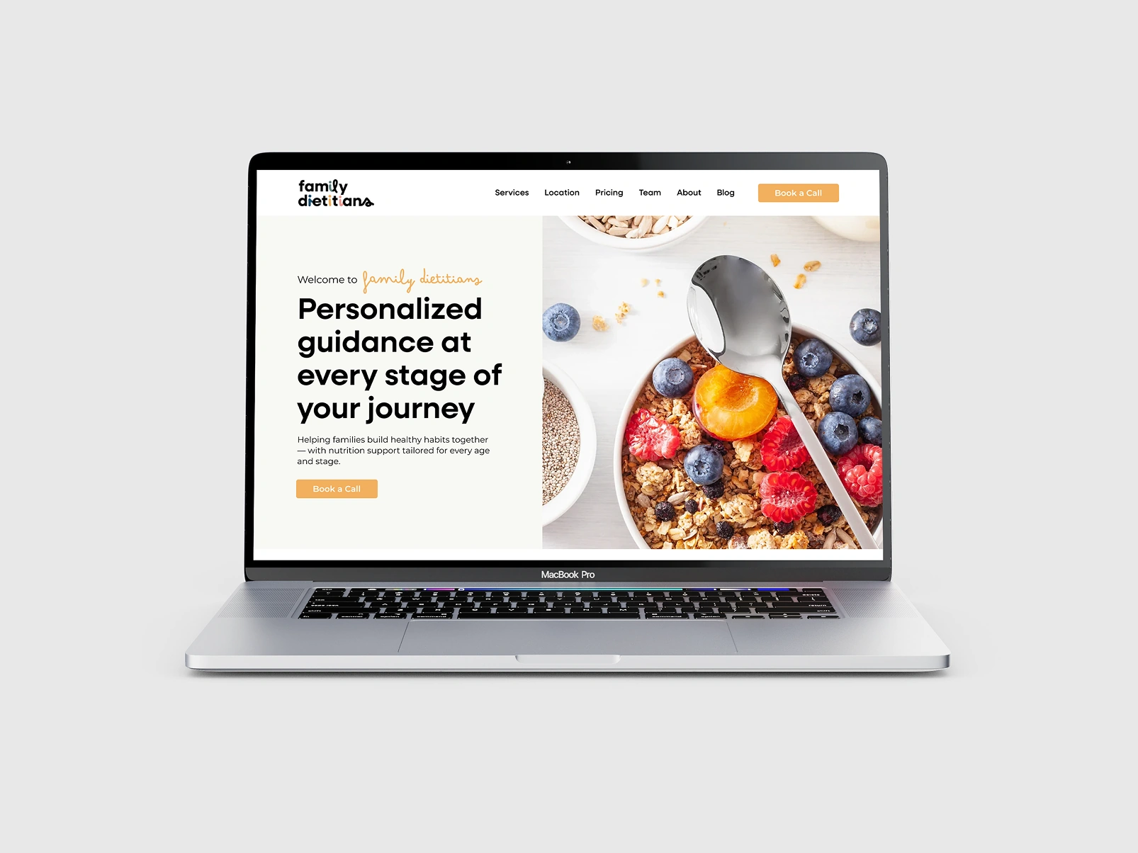 Family Dietitians website homepage on a MacBook Pro, with the headline “Personalized guidance at every stage of your journey” beside a bowl of granola and berries
